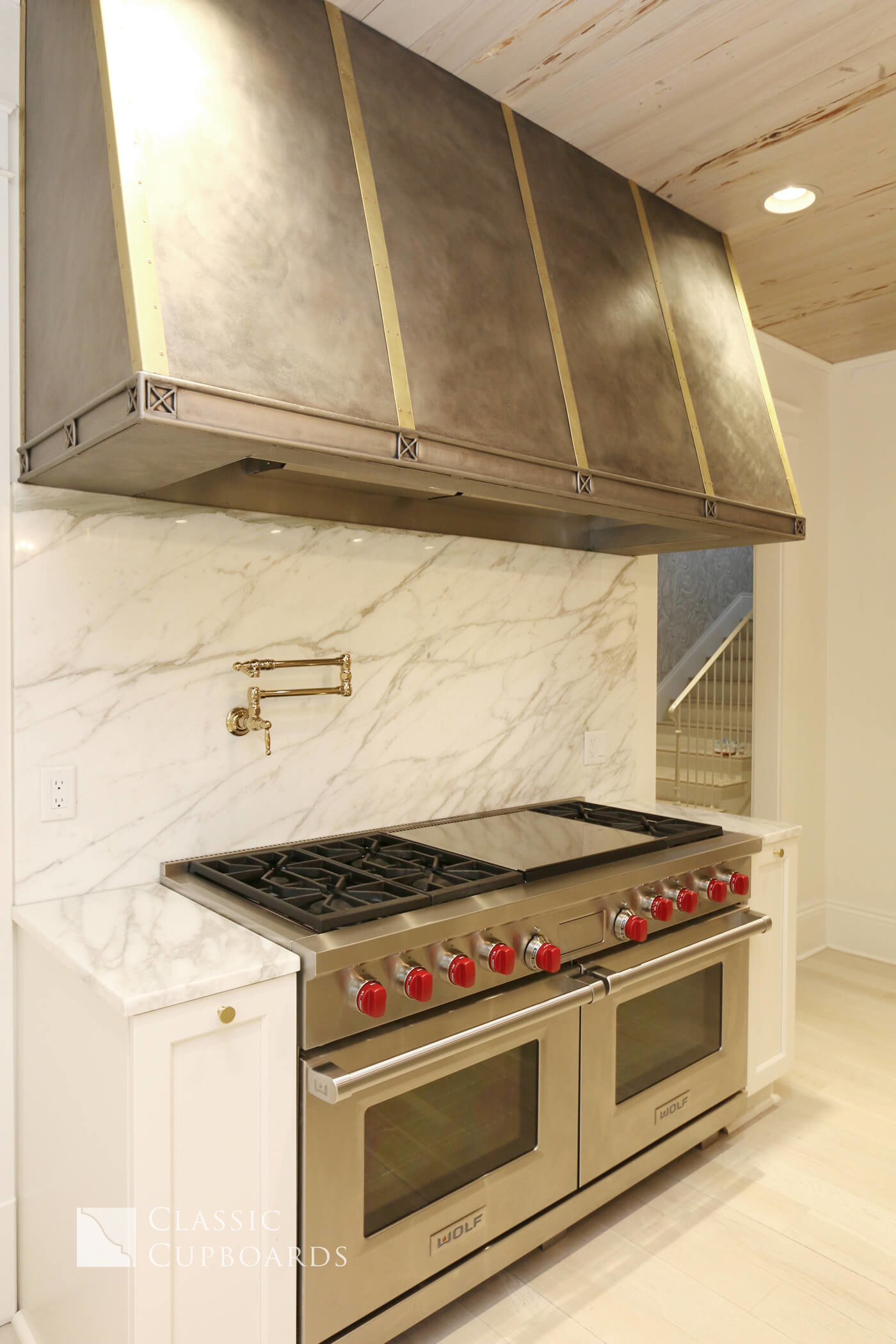 Transitional Kitchen with custom metal hood