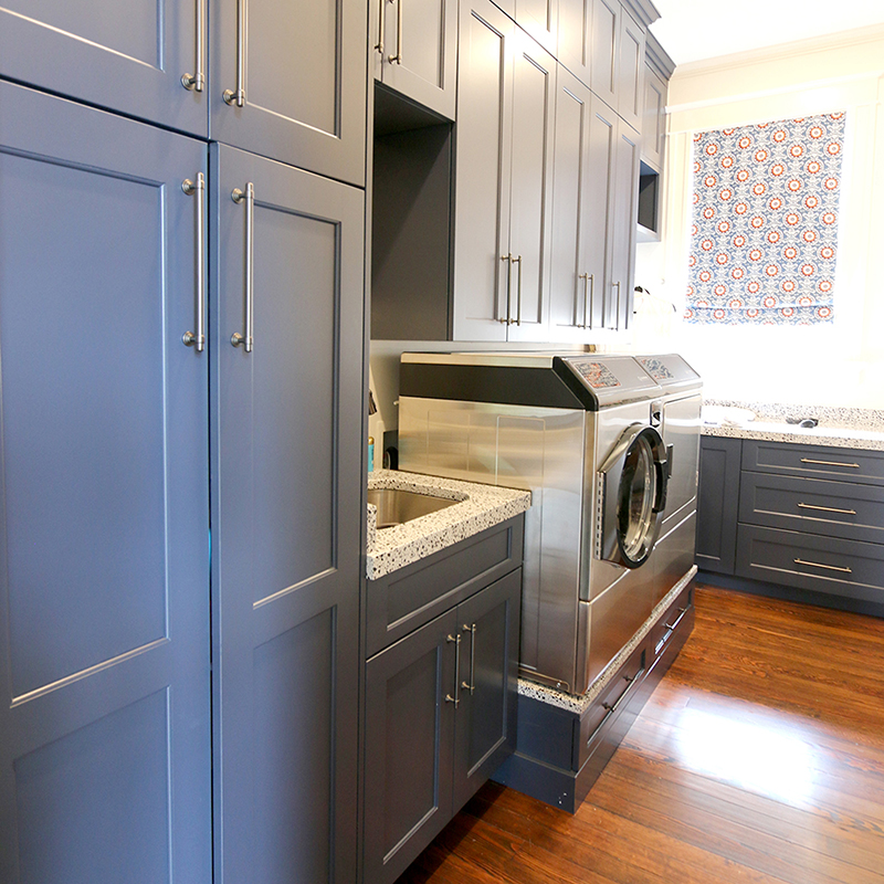 custom laundry room with blue cabinets